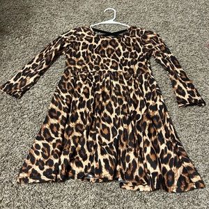Leopard print girls dress with cross cross upper back. Size 7/8